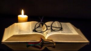 Biblical Declarations - Glasses and Candle On Open Bible