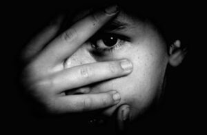 Emotional Abuse Is Physical Abuse - Black and White Image of Girl With Hand Over Eyes
